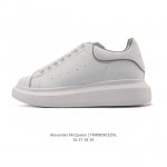 Alexander McQueen's white sneakers, featuring thick soles, height-enhancing gli